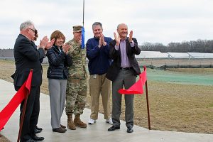 U.S. Rep. Tim Walz (from left), Minnesota state Sen. Carrie Ruud (behind Walz), Minnesota Lt. Gov. Tina Smith, Maj. Gen. Richard Nash and ALLETE Chairman, President and CEO Al Hodnik (far right) applaud after cutting the ribbon for the solar power plant at Camp Ripley on Thursday (April 13)